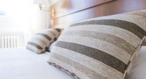 beige pillows on a white bedspread