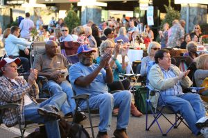 Seated crowd enjoy live jazz music on Edgewater Drive during College Park JazzFest 2016