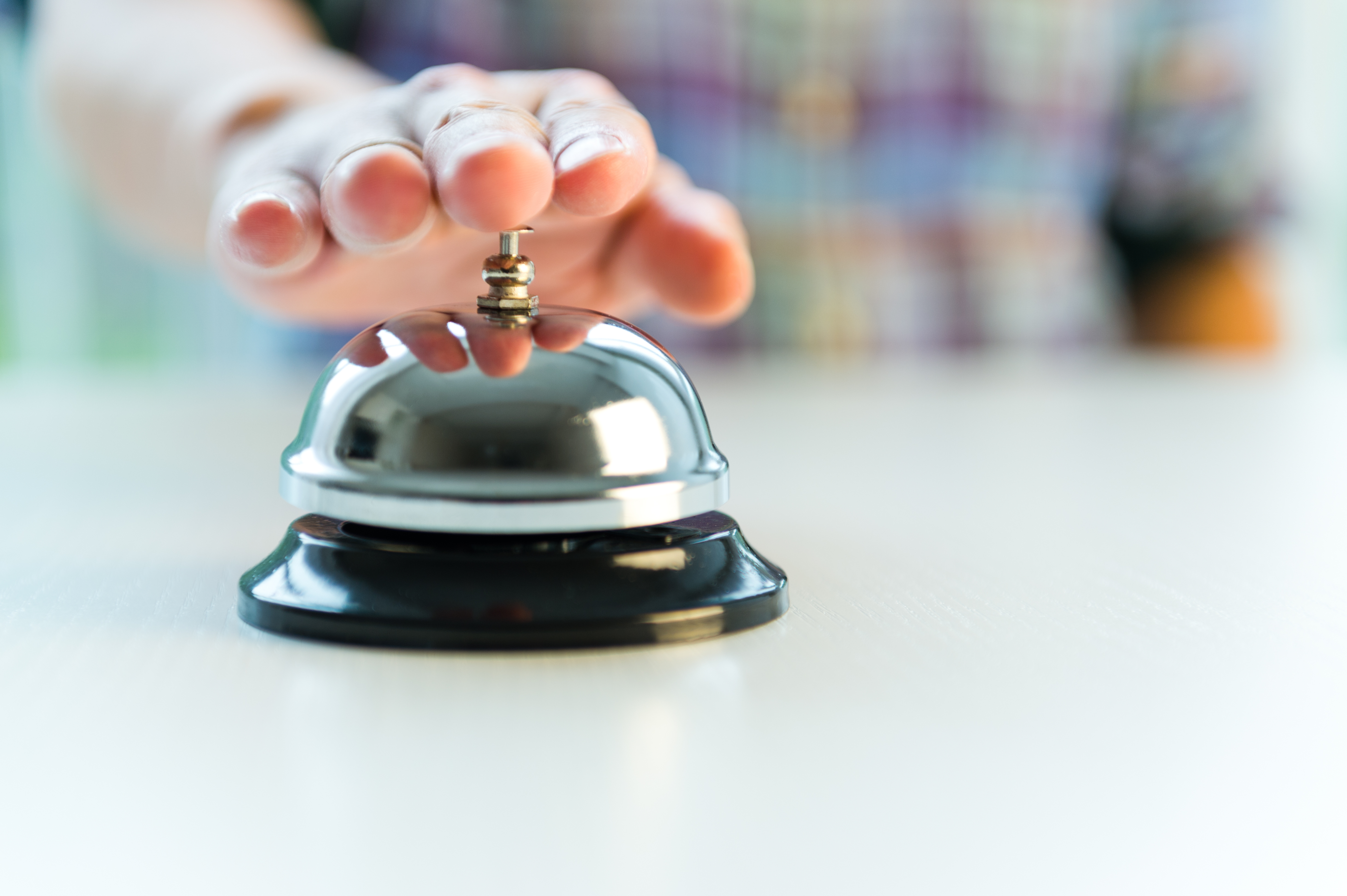 Hotel service bell with customers hand 